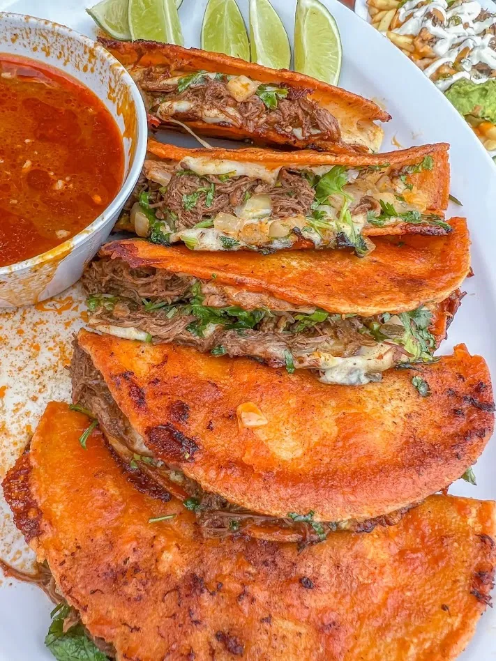 Quesabirria tacos with consommé for dipping
