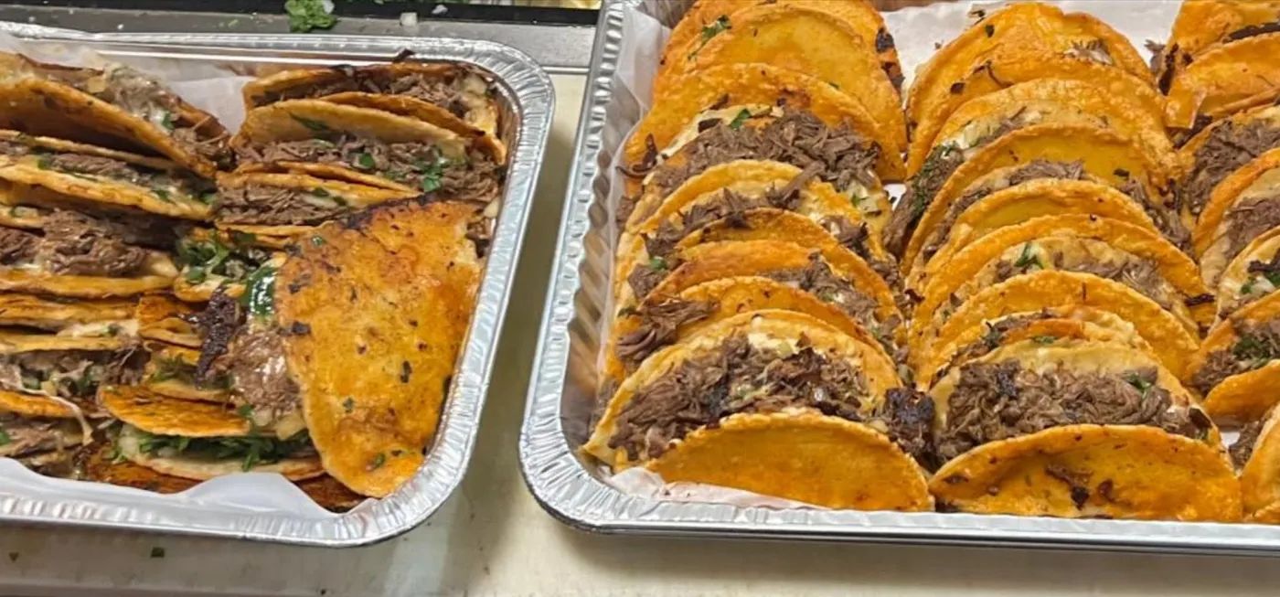 Full catering trays of quesabirria tacos ready for delivery in San Bernardino