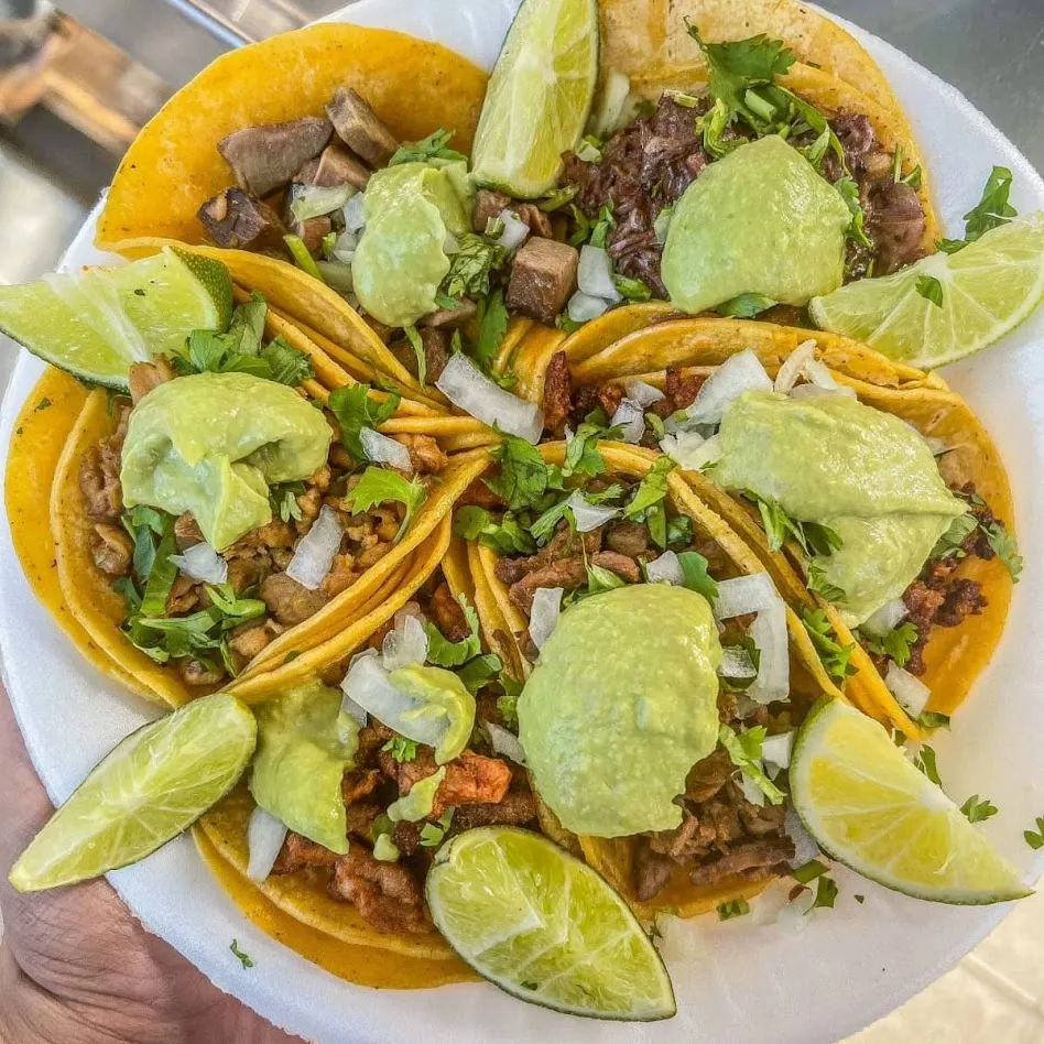 Street tacos platter with avocado salsa and lime